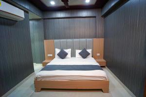 a bedroom with a large bed in a room at Hotel Konark INN in Bareilly