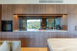 a kitchen with a large window with a view at Casa Celeste, Grand Architectural Residence in Wollongong