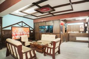 a living room with a couch and chairs and a table at Hotel Konark INN in Bareilly