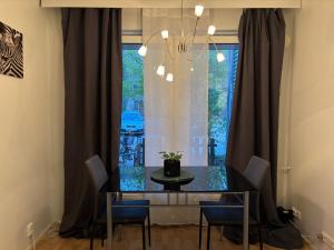 a dining room with a glass table and chairs at Cozy Apartment with Private Sauna in Vaasa