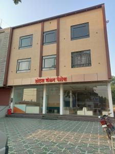 a building with a street view of a store at Hotel Shankar Place in Khātu