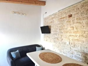 a living room with a couch and a table at Stone House Mate in Rovinjsko Selo