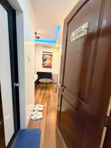 a door leading into a room with shoes on the floor at Manatad Transient Deluxe Room 2 in Surigao