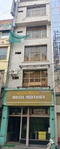 a building with a sign on the front of it at Hotel Midtown in Rourkela
