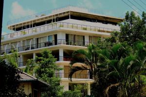 a white building with balconies and trees at Sky View Grand in Kandy +30 photos