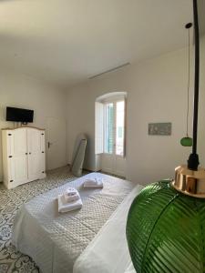a bedroom with a bed with two towels on it at Il Pumo in Locorotondo +38 photos