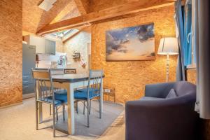 a kitchen and dining room with a table and chairs at Bungalows im Grünen in Lychen +46 photos
