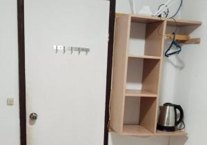 a wooden book shelf next to a door at Cliff Cabanas by Hiverooms in Catmon