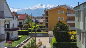 a view of a city with mountains in the background at Giulietta Apartment Cuneo in Cuneo