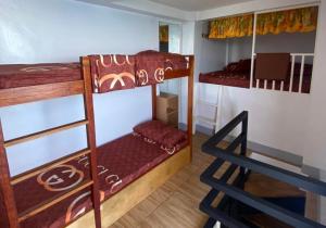a room with two bunk beds and a ladder at Cliff Cabanas by Hiverooms in Catmon +33 photos