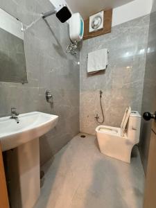 a bathroom with a toilet and a sink at Hotel The Edge in Rewa +21 photos