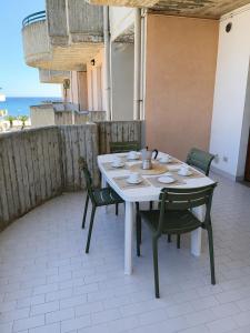 a table and chairs on a patio with a view of the ocean at On the Beach in Tortoreto Lido +40 photos