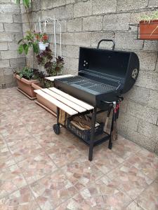a black piano and a bench next to a wall at La casa di Nonna Carta in Fordongianus
