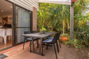 a patio with a table and chairs on a porch at Sandpiper 21 in Smiths Lake +17 photos