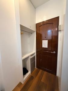 a closet with a wooden door in a room at Manatad Transient Family -2 in Surigao