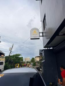 a car parked next to a sign for a restaurant at Manatad Transient Family -2 in Surigao +7 photos