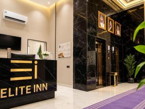 a lobby with a black and gold reception desk at إليت إن - ELITE INN Serviced Apartments in Qal'at Bishah +24 photos