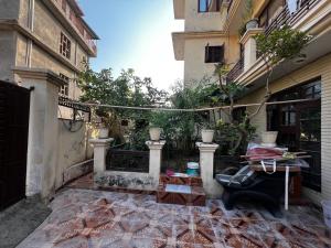 a courtyard of a building with a gate and a bench at Home stays subash nagar in Jammu