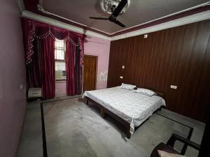 a bedroom with a bed and a ceiling fan at Home stays subash nagar in Jammu