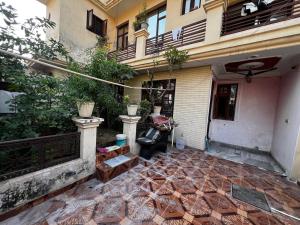 a courtyard of a building with a bench and a chair at Home stays subash nagar in Jammu +7 photos