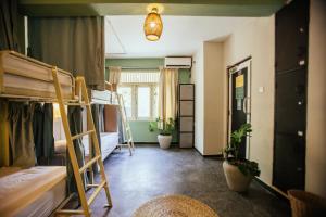 a dorm room with bunk beds and a hallway at Drop Inn Hostels in Colombo