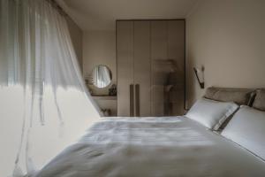 a bedroom with a white bed and a window at Akari - Luxury Apartment in Preveza