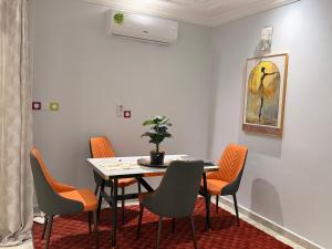 a dining room with a table and chairs at Egel appartement in Yaoundé