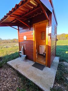 a out house with a toilet in a field at Duva jurta in Bistrica +7 photos