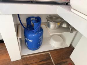a blue water bottle in a shelf in a drawer at Manatad Transient Deluxe 3 in Surigao