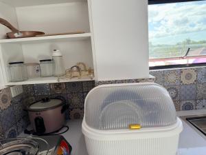 a white refrigerator in a kitchen with a sink at Manatad Transient Deluxe 3 in Surigao +8 photos