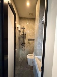 a bathroom with a toilet and a sink at Manatad Transient Deluxe 3 in Surigao