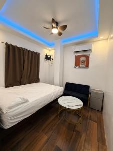 a bedroom with a bed and a ceiling fan and a table at Manatad Transient Deluxe 3 in Surigao