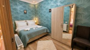 a bedroom with a bed with towels on it at Bereka Apartment in Mtskheta in Mtskheta