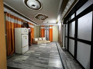 a hallway with a refrigerator and a couch in a room at Home stays subash nagar in Jammu