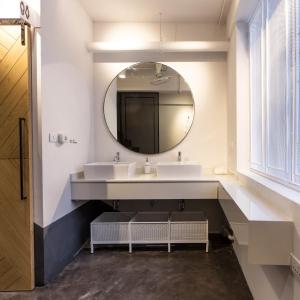 a bathroom with two sinks and a mirror at Bed One Block Hostel in Bangkok