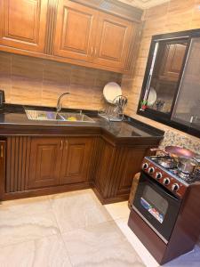 a kitchen with a stove and a sink at Egel Appartement in Yaoundé