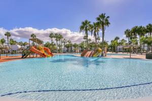 a large swimming pool with slides at a resort at Oasis Duna _ Casa Mate Pool in Corralejo