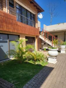a house with two large pots on the side of it at Zungu b&b in KwaDukuza