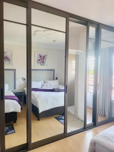 a bedroom with sliding glass doors leading to a bed at Zungu b&b in KwaDukuza