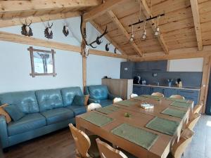 a living room with a table and a blue couch at Jagerhof in Râşnov