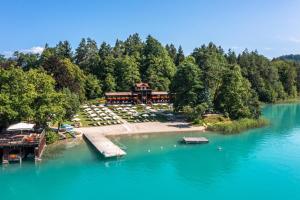 an aerial view of a resort on a lake at Inselhotel Faakersee in Faak am See