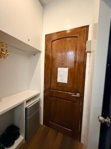 a large wooden door in a room with a shelf at Manatad Transient Family 3 in Surigao +14 photos