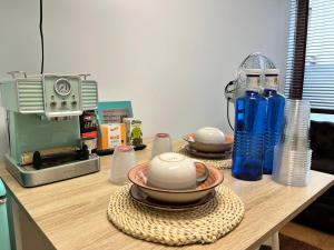 a kitchen counter with bowls and a coffee maker on it at Estudio bajo la escalera in Redondela