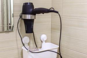 a blow dryer is hanging on a wall at Franc Llagami - Rooms - 2 in Vecsés