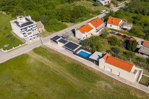an aerial view of a house with a yard at Villa Ante - Private Pool, Wellness & Gym in Šestanovac