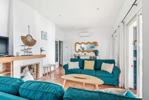 a living room with a blue couch and a fireplace at Villa Casa de Olives by Escape Home in Cala Galdana