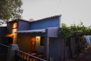 a blue house with a fence in front of it at La Casa de Doña Adela in Eugenio Bustos