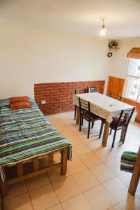 a dining room with a table and chairs at La Casa de Doña Adela in Eugenio Bustos