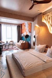 a bedroom with a large bed and a living room at Inn OZZ Almaty in Almaty +94 photos