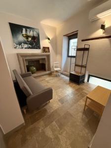 a living room with a chair and a fireplace at Alla botte degli Orsini in Attigliano